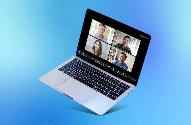 Laptop showing a Zoom video call with four participants in gallery view